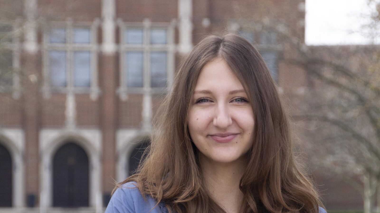 Elizabeth O'Loughnane, Intern Architect, photographed in front of a collegiate Gothic building